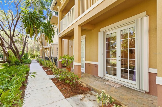 doorway to property featuring french doors and stucco siding