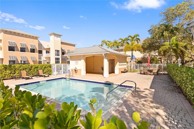 community pool featuring a patio area and fence