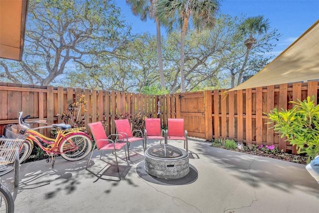 view of patio featuring a fenced backyard and an outdoor fire pit