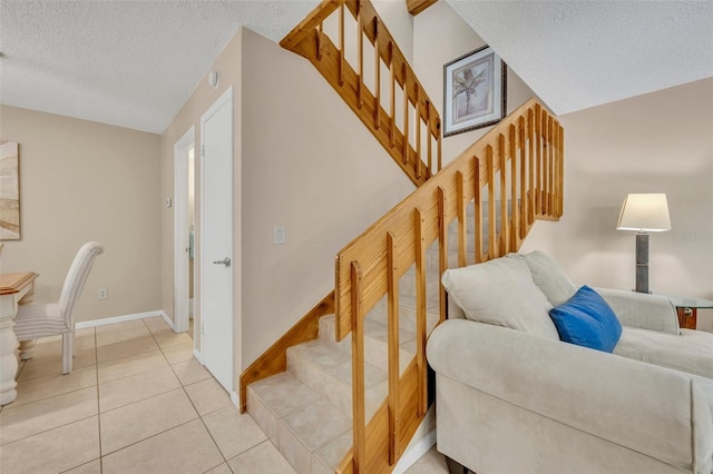 135 Cedar Dunes Dr, New Smyrna Beach, FL 32169 - staircase featuring baseboards, a textured ceiling, and tile patterned floors