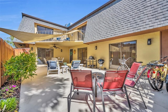 135 Cedar Dunes Dr, New Smyrna Beach, FL 32169 - view of patio featuring fence, a ceiling fan, a balcony, and outdoor dining space