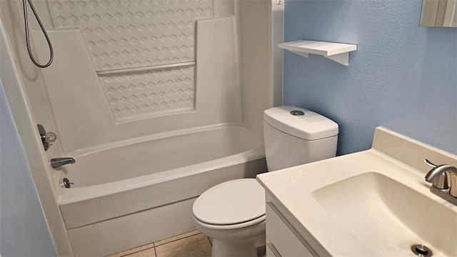 bathroom featuring vanity, shower / washtub combination, tile patterned floors, toilet, and a textured wall