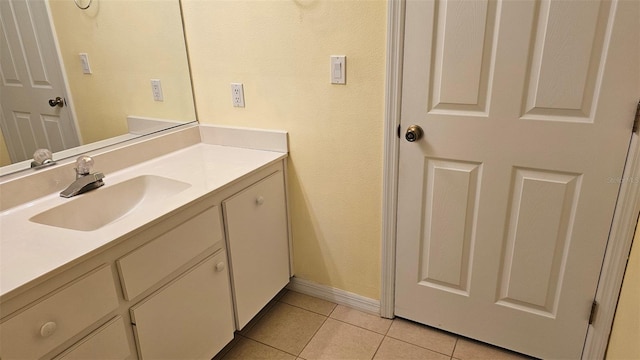 bathroom with tile patterned floors, baseboards, and vanity