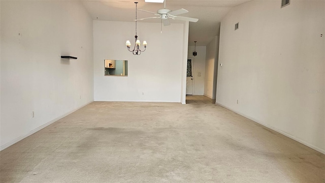 unfurnished room with visible vents, carpet, high vaulted ceiling, and ceiling fan with notable chandelier