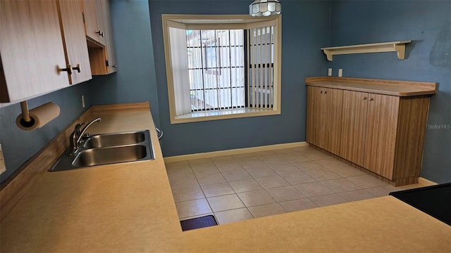 kitchen featuring visible vents, a sink, baseboards, light tile patterned floors, and open shelves