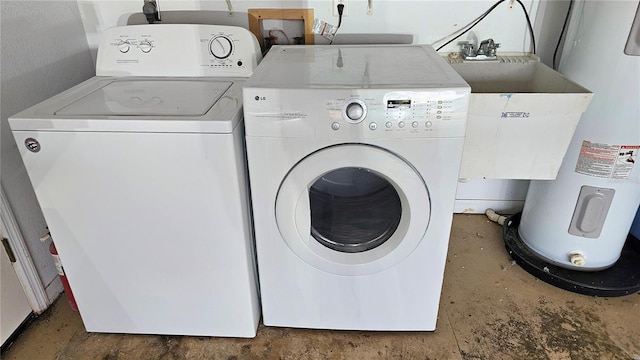 clothes washing area featuring water heater, washer and dryer, and a sink