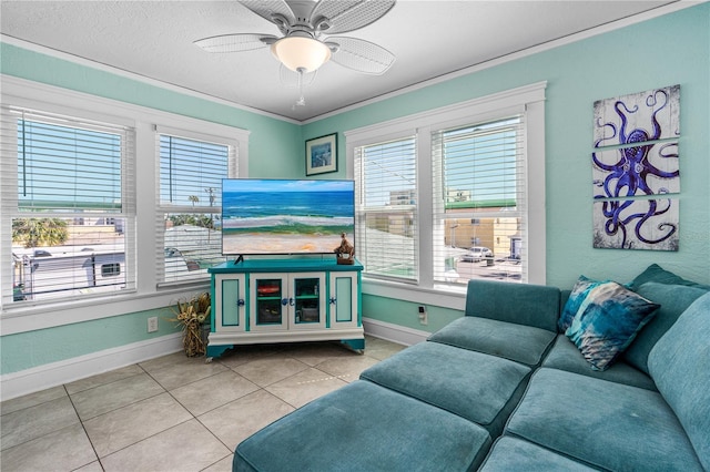 living area featuring crown molding, light tile patterned floors, a healthy amount of sunlight, and baseboards