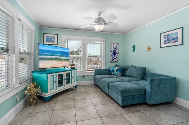 tiled living room with ceiling fan, crown molding, and baseboards