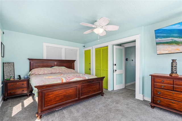 carpeted bedroom with a closet, baseboards, and ceiling fan