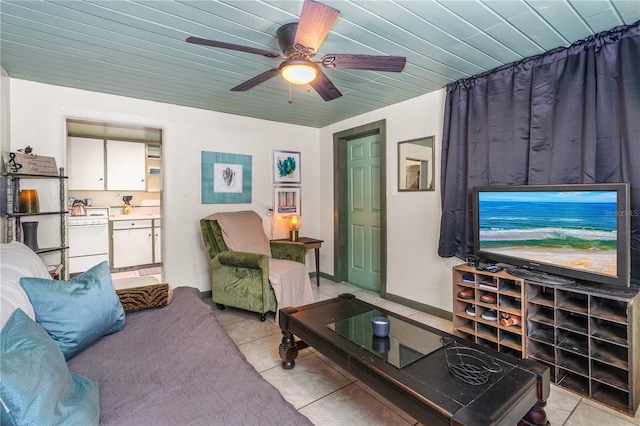 living area featuring light tile patterned floors, wood ceiling, baseboards, and ceiling fan