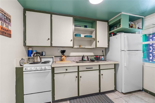 kitchen featuring white appliances, light countertops, open shelves, and a sink