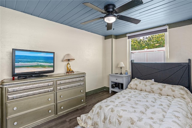 bedroom featuring wood ceiling, dark wood-type flooring, baseboards, and a ceiling fan