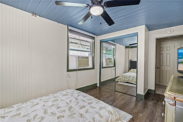 bedroom featuring cooling unit, a closet, wood finished floors, and a ceiling fan