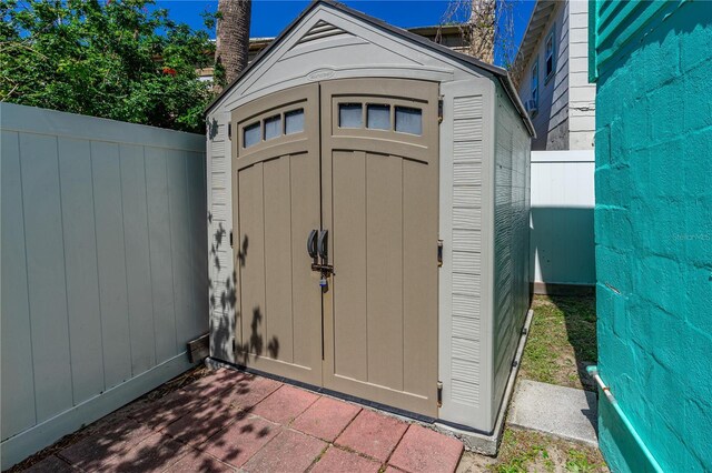 view of shed with fence