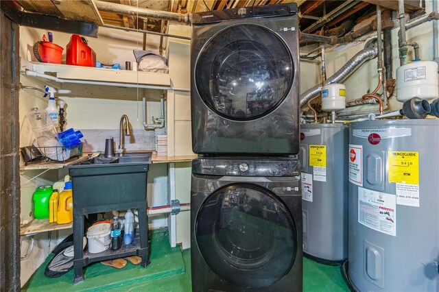 laundry room featuring electric water heater and stacked washer and clothes dryer