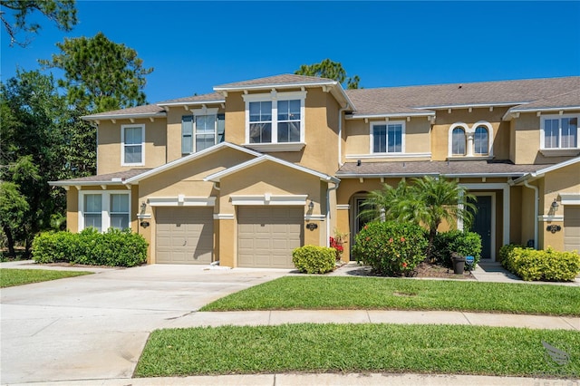 townhome / multi-family property featuring stucco siding, a garage, and concrete driveway