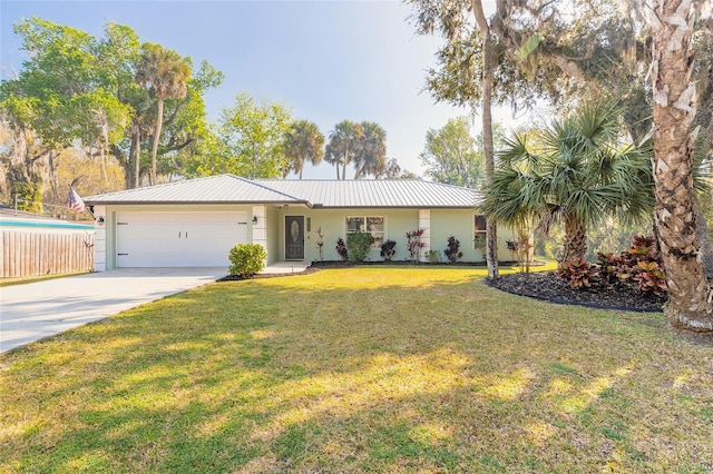 ranch-style home with a front yard, an attached garage, stucco siding, concrete driveway, and metal roof