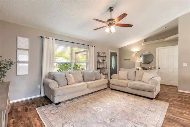 living area featuring lofted ceiling, wood finished floors, baseboards, and a textured ceiling