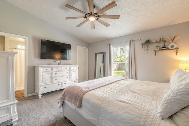 bedroom with vaulted ceiling, carpet flooring, connected bathroom, and a textured ceiling