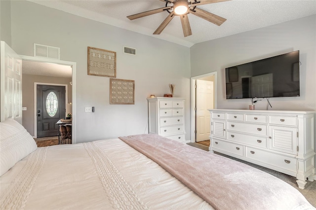 bedroom with visible vents, a textured ceiling, ceiling fan, and vaulted ceiling