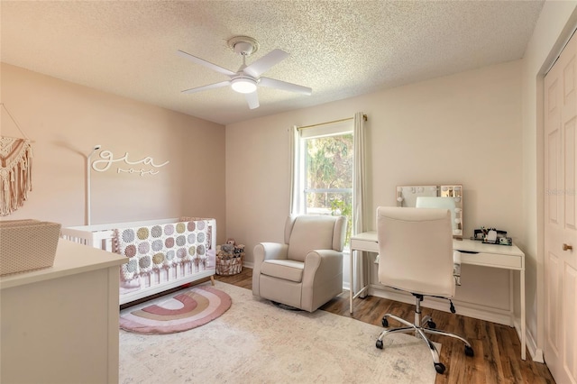 home office with ceiling fan, wood finished floors, and a textured ceiling