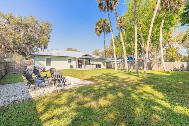 view of yard with a gazebo, a fenced backyard, and a patio area