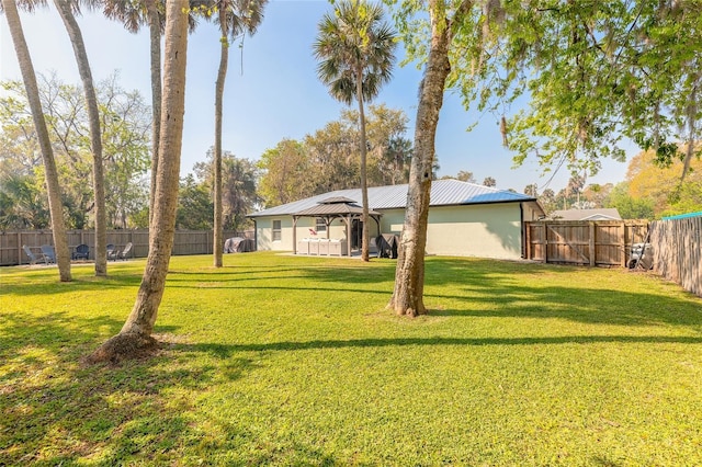 view of yard featuring a gazebo and a fenced backyard