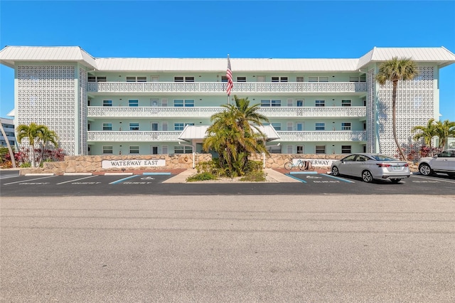 view of building exterior with uncovered parking