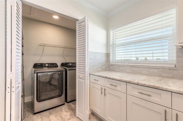 laundry room featuring recessed lighting, light wood-type flooring, laundry area, and washer and clothes dryer