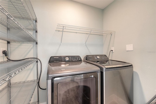 clothes washing area featuring laundry area and washer and dryer