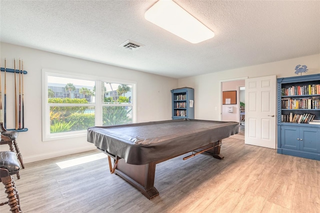 recreation room with light wood-type flooring, visible vents, billiards, a textured ceiling, and baseboards