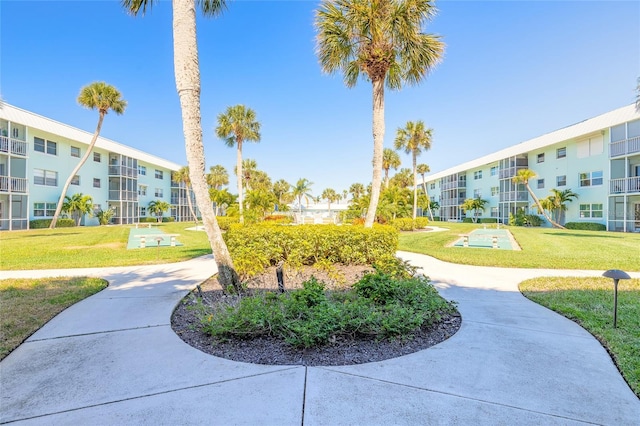 view of property's community with a lawn