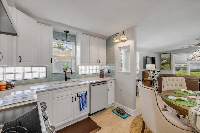 kitchen featuring white cabinetry, dishwashing machine, decorative backsplash, and a sink