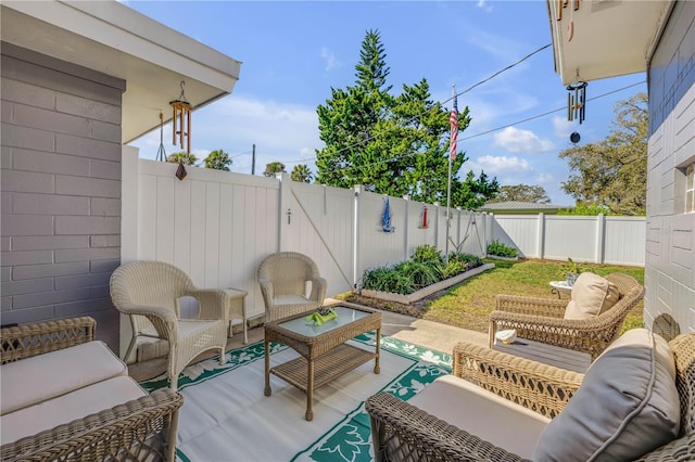 view of patio / terrace with an outdoor living space and a fenced backyard