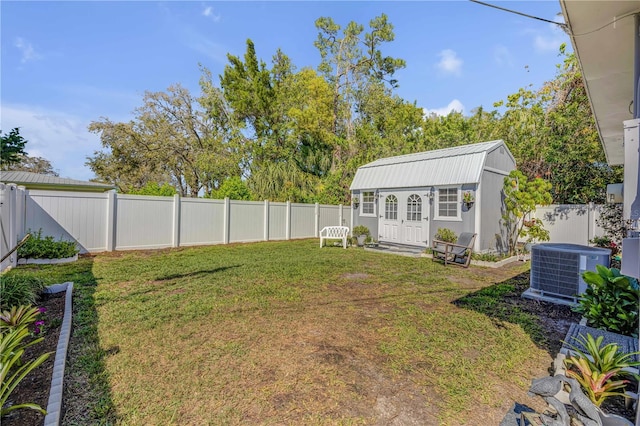 view of yard with an outdoor structure, central AC unit, and a fenced backyard