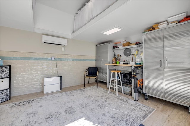 garage featuring a workshop area and a wall mounted air conditioner