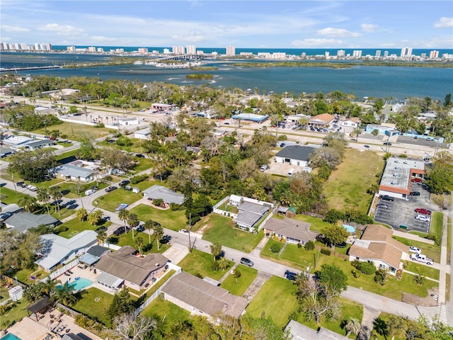 birds eye view of property featuring a water view and a city view