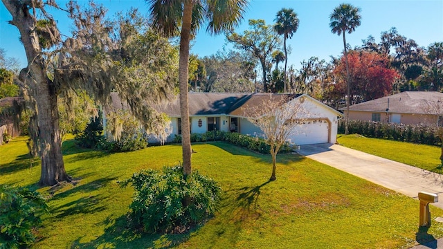 ranch-style house featuring driveway, a front yard, and an attached garage