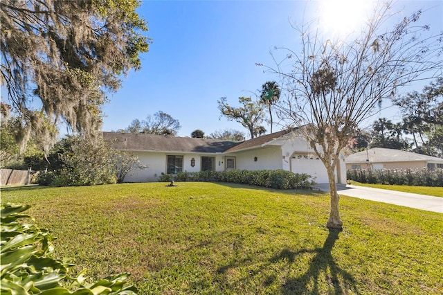 ranch-style home featuring stucco siding, a front lawn, an attached garage, and driveway