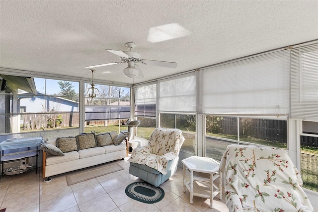 sunroom / solarium featuring a ceiling fan