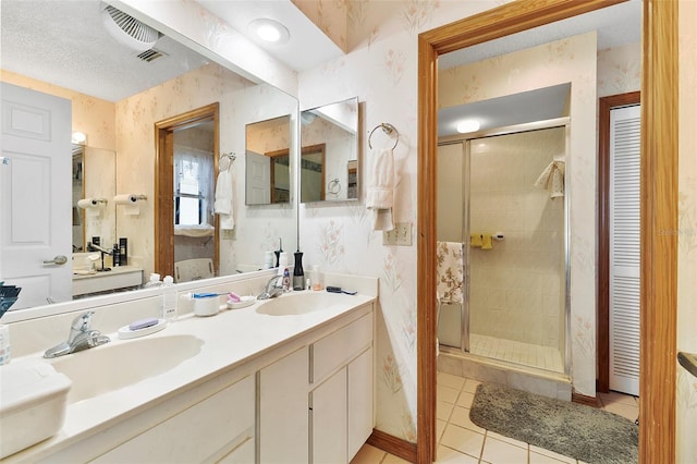 full bath featuring wallpapered walls, a stall shower, and a sink