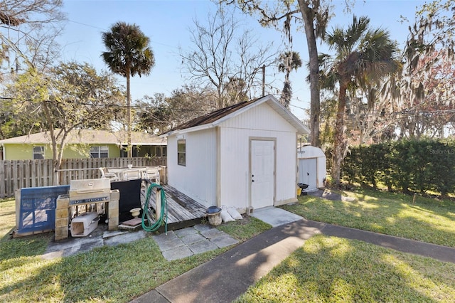 view of shed featuring fence