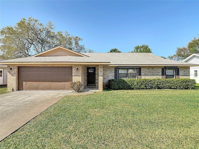 ranch-style house featuring brick siding, concrete driveway, a front yard, roof with shingles, and an attached garage