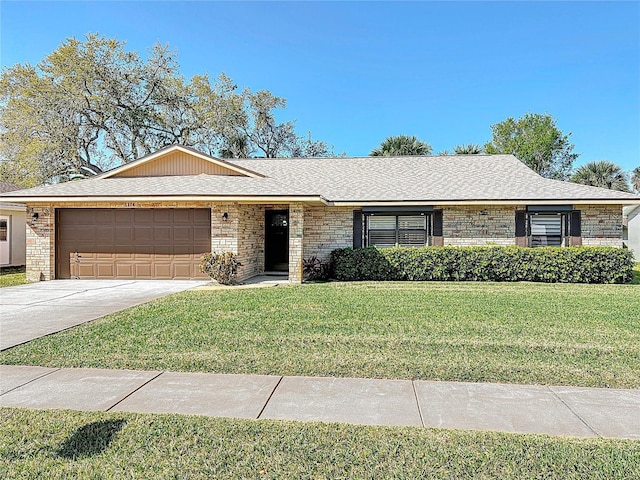 ranch-style home featuring a front lawn, driveway, an attached garage, a shingled roof, and brick siding