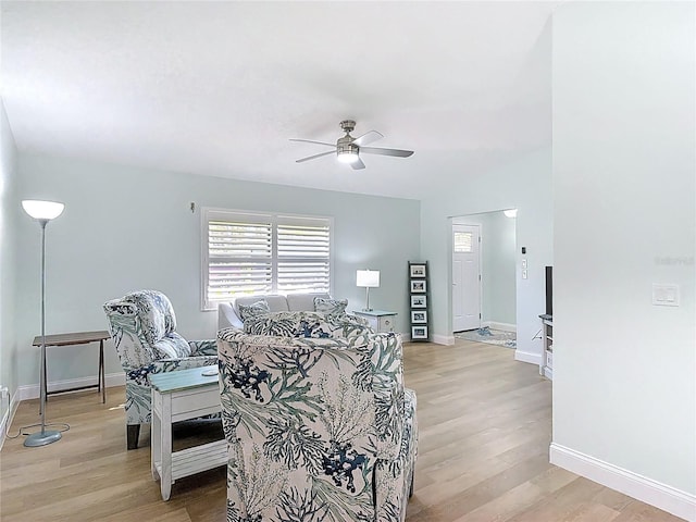 interior space with baseboards, light wood-style flooring, and a ceiling fan