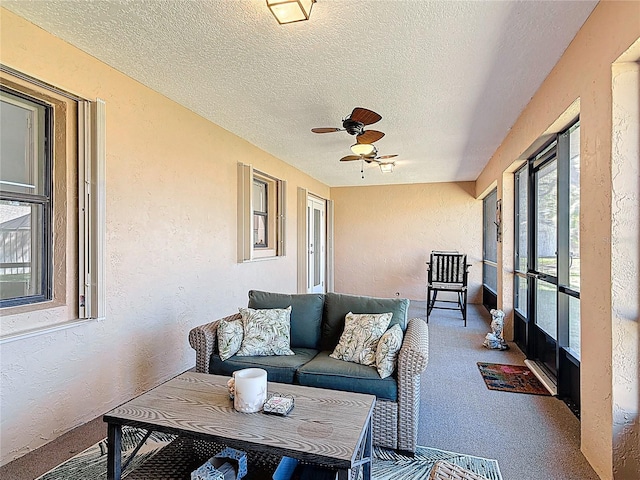 sunroom / solarium with a ceiling fan