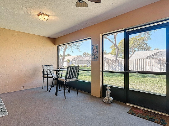 sunroom / solarium featuring a ceiling fan and a healthy amount of sunlight