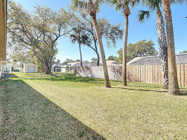 view of yard featuring cooling unit and fence