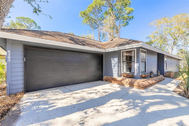 view of front of home featuring concrete driveway and a garage