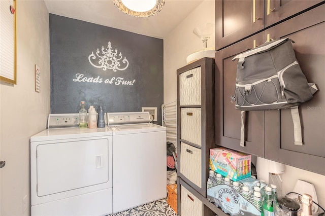 laundry room featuring washer and clothes dryer and cabinet space